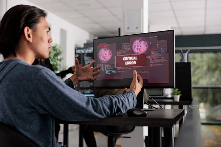 Desarrollador frustrado frente a pantalla con mensaje de error crítico en servidor local