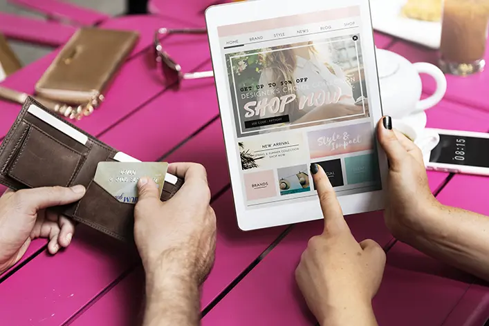 People making an online purchase on a tablet in a casual setting.